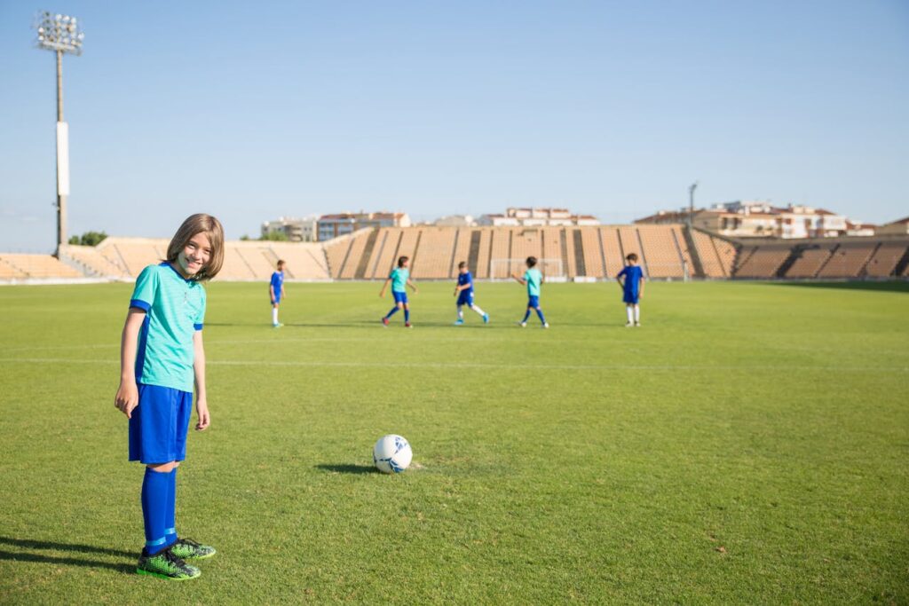 Children playing safely on natural grass in a school playground